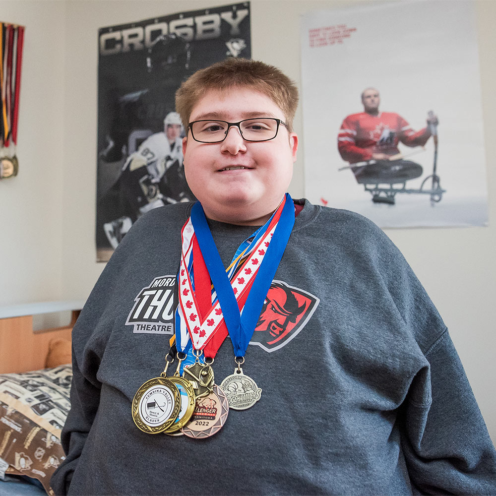 Evan smiling with award medals around neck